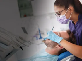 A dentist performs a cleaning on her patient.