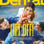 The August Scottish Dental mag cover annouces the 'Lift off' of Glasgow University's new oral health centre. A group of people Hi-Five towards the centre of the cover image.