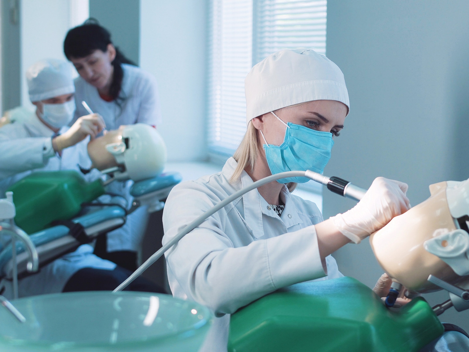 Trainee dentists practice techniques on dummy patients.