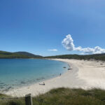 A pristine beach cove on a bright sunny day.