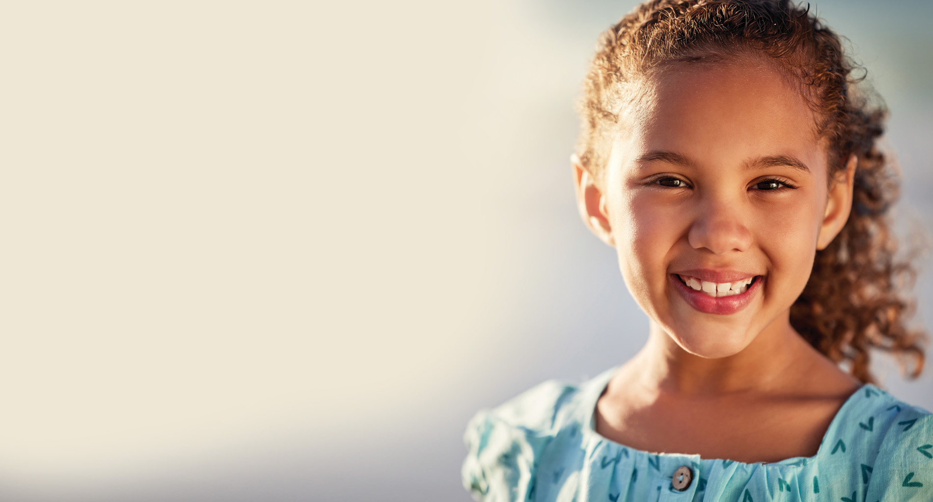 An image of a young girl smiling at the camera