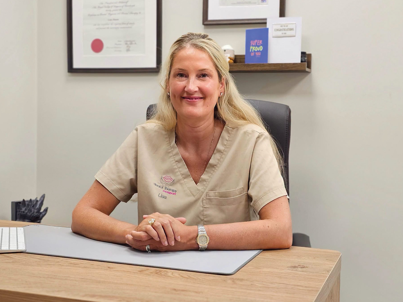 Lisa sitting at her desk in her office.