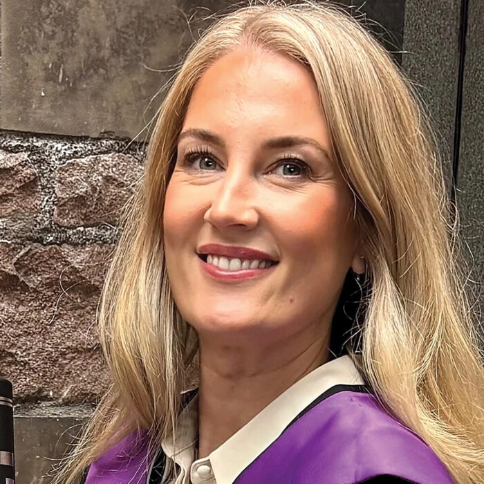 Lisa in her Masters graduation gowns.